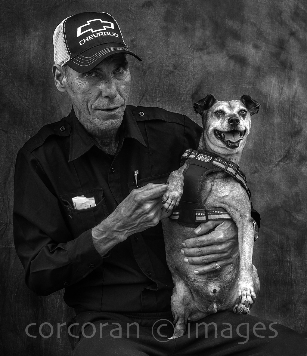 Black and white image of a formal portrait of a man and his dog